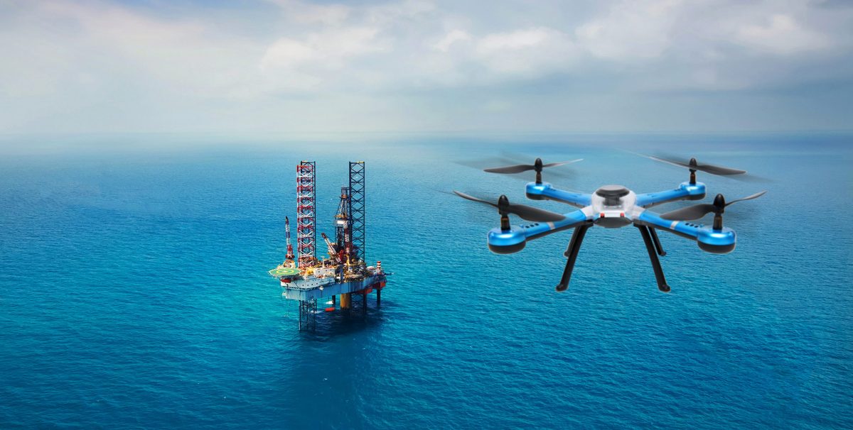 A drone hovering over an oil rig